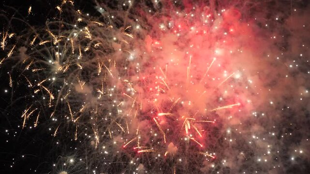 4k. Bright New Year's fireworks 2023. beautiful new year's eve. glowing loop christmas bokeh. holiday day christmas. beautiful bright color spot show. eve New Year's holiday. national festival sky