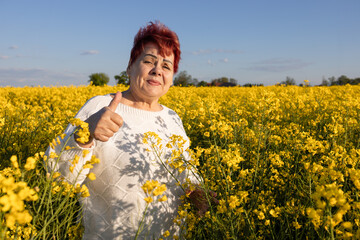 Happy mature woman has resistance to allergies and does not experience problems in the pollen field