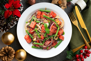 Summer salad with watermelon, fennel and green beans. Top view table with christmas decorations.