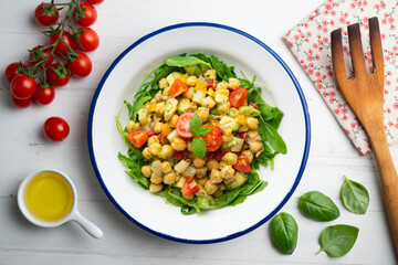 Mediterranean chickpea salad with avocados and vegetables. Top view table with christmas decorations.