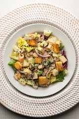 Waldorf salad with apple, raisins, walnuts, and mayonnaise dressing. Top view table with christmas decorations.