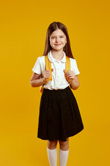 Smiling child with a yellow backpack standing confidently, embodying happiness and readiness for school. Ideal for educational materials and back-to-school promotions.