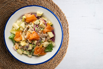 Waldorf salad with delicious smoked salmon, apple, raisins, walnuts, and mayonnaise dressing.