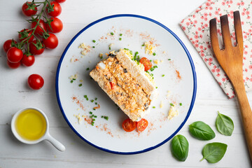 Cold tuna pie with vegetables and sliced ​​bread.  Top view table with christmas decorations.