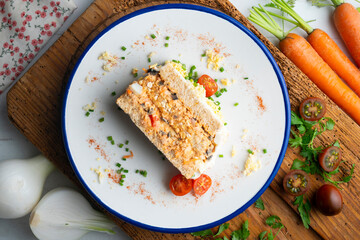 Cold tuna pie with vegetables and sliced ​​bread.  Top view table with christmas decorations.