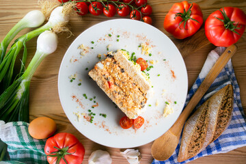 Cold tuna pie with vegetables and sliced ​​bread.  Top view table with christmas decorations.