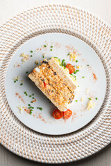 Cold tuna pie with vegetables and sliced ​​bread.  Top view table with christmas decorations.