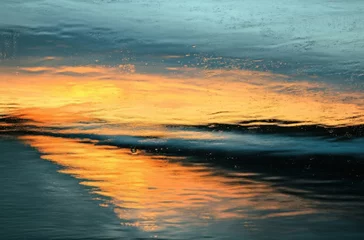 Sunset reflected on car driving down coastal road
