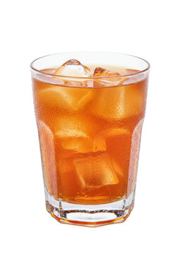 Iced tea in glass with ice cubes, condensation on glass, and amber hue in bright light