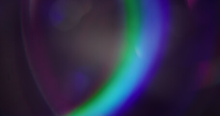 Lens flare. Defocused glow. Green purple blue color blurred reflection bokeh light radiance...