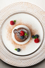 Beautiful chocolate lava cake coulant from a top view with christmas decorations.