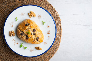 Triangular English scones with dark chocolate chips. Top view table with christmas decorations.