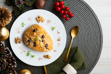 Triangular English scones with dark chocolate chips. Top view table with christmas decorations.