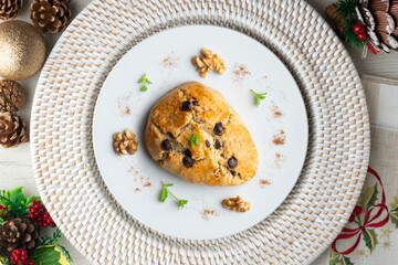 Triangular English scones with dark chocolate chips. Top view table with christmas decorations.