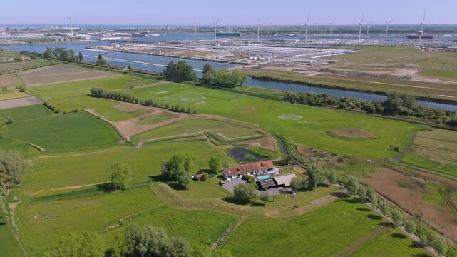 Aerial Over Farmhouse with Canal and Distant Port &ndash; Lissewege by FlyLens