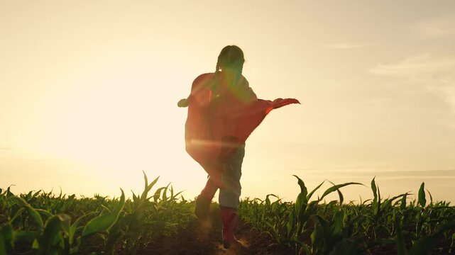 agriculture, child running red cape superhero, corn field sunset, wheat farming, children dream superhero flying, game win save help, children running in the countryside, happy family, concept corn