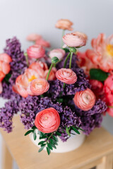 
stylish set of flowers in a box on the table spring lilac peonies and ranunculus