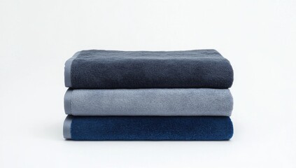 Stacked bath towels in varying shades of blue