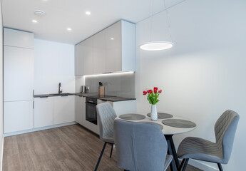 Modern Minimalistic Kitchen With Dining Table and Elegant Grey Chairs