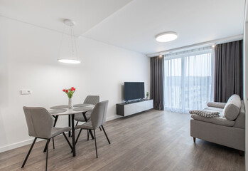 Modern Living Room With Dining Table and Large Windows for Natural Lighting