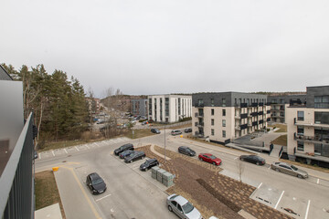 Modern Apartments Surrounding a Quiet Road with Parking and Trees