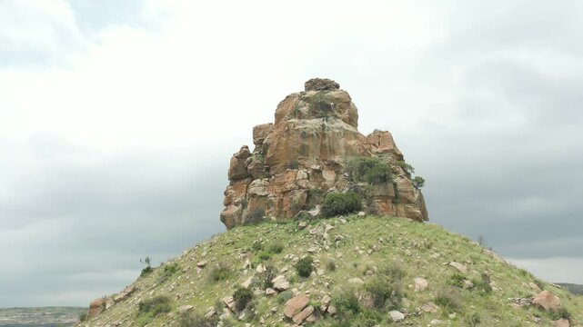 Fly around top of Qiloane Hill, looking up at the intricate sandstone formation