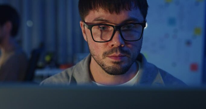 Closeup team adult male freelance work late typing write prompt AI bot app program nomad terminal code at office night. Artificial intelligence dashboard, robotics, user interface, machine learning.