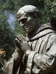 Closeup View of Saint Junipero Serra Statue at Mission San Jose, Fremont, Showcasing Green Surroundings on a Clear Day