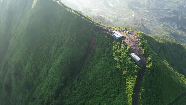 aerial view of green mountains with hiking trails on Mount Andong, Central Java, Indonesia