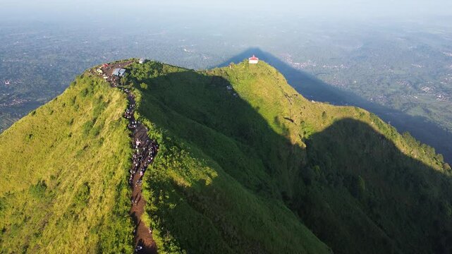 aerial view of green mountains with hiking trails on Mount Andong, Central Java, Indonesia