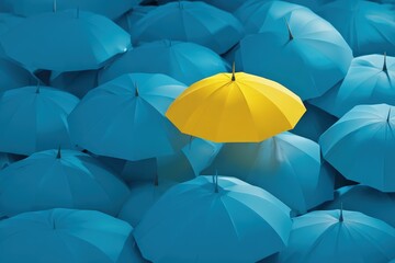 Vibrant yellow umbrella among blue ones.