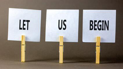 Let us begin symbol. Concept words Let us begin on beautiful white paper on clothespin. Beautiful...