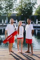 Lifeguards posing by the swimming pool edge