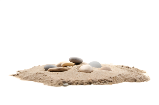 Smooth stones resting on a small pile of light brown sand against a black background