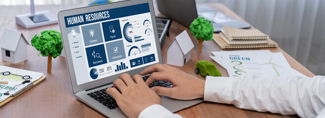 Human resources management software on computer screen helping human resources employee to manage...