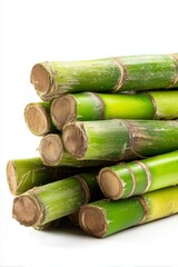 Precision-cut sugarcane billets stacked for planting in soft natural lighting against a white background