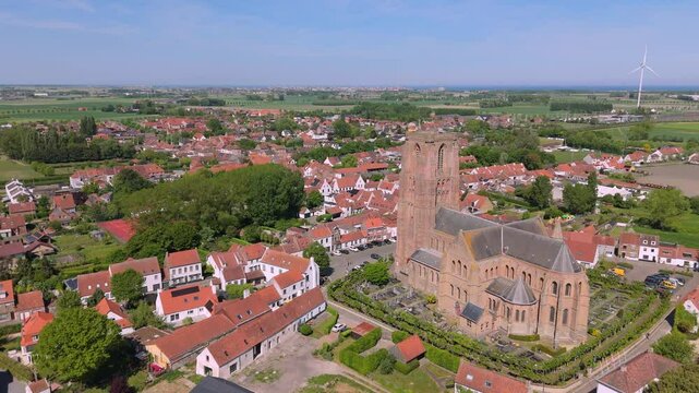 Church Flyby Over Lissewege &ndash; Elevated Village Aerial by FlyLens