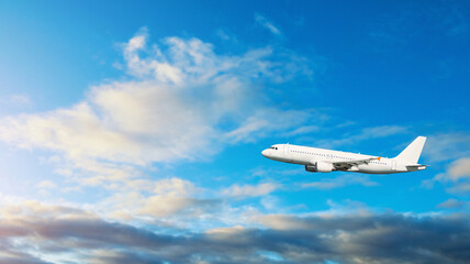 Airplane flying in the sky, travel background with blue sweeping sky and white commercial airplane...