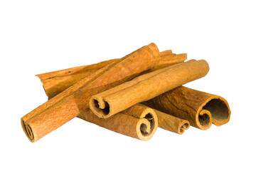 Flat lay of cinnamon bark shards on a white background, capturing their organic shapes and fibrous details.