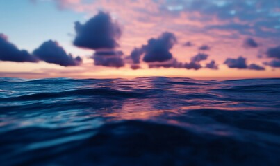 Fototapeta premium Captivating ocean sunset scenery, with clouds above the water and colors of pink and blue