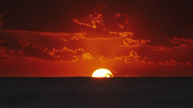 Vibrant sunset over ocean with dramatic clouds at dusk, timelapse 4k