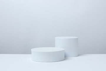 White podiums on a light background. Clean empty wall scene. Minimal mockup or abstract product display presentation, Stage showcase. Platforms vector geometric design