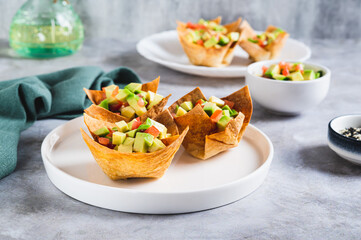 Appetizing cups of guacamole in pita bread on a plate on the table