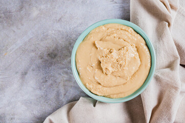 Close up of sesame tahini in a bowl on the table top view