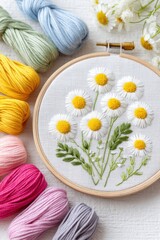 Embroidery hoop displaying vibrant daisies with yellow centers and green leaves, surrounded by colorful threads, showcasing the art of textile crafting and creativity