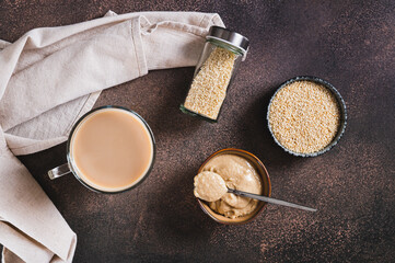 Tahini latte with sesame spread in a cup on the table top view