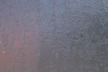 Cracked black paint on iron gates in the sun as a background, old black paint