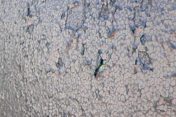 Cracked black paint on iron gates in the sun as a background, old black paint