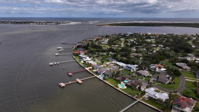 Aerial view of inner St Augustine Beach in Florida showing city streets and business with homes beside peaceful inlet shore on a beautiful warm summer day at the height of tourist season 