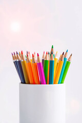 Colored pencils in a white holder, vibrant and ready for artistic creativity and drawing.